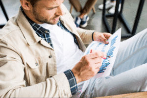 Person analyzing data report for informed decision-making.