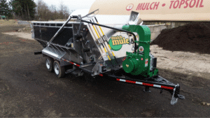 Topsoil and mulch delivery trailer on-site, ready for service.