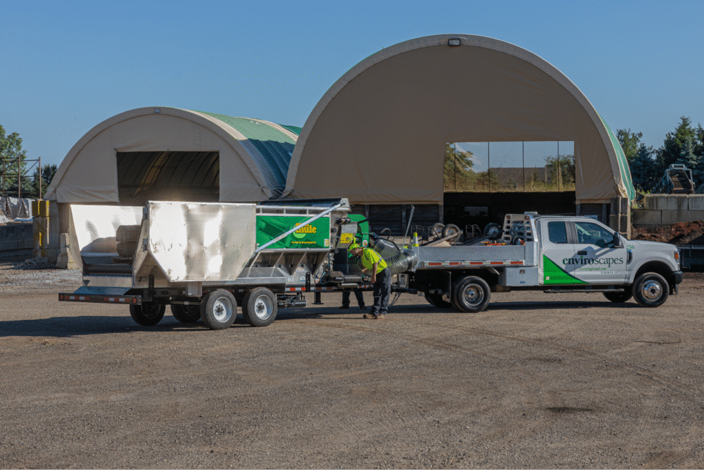 Mulch Mule with materials at an industrial site with storage facilities.