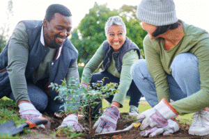 Community members gardening together, promoting teamwork and environmental stewardship.
