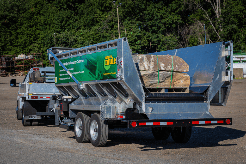 Dump trailer loaded with rocks, ideal for landscaping and construction projects.