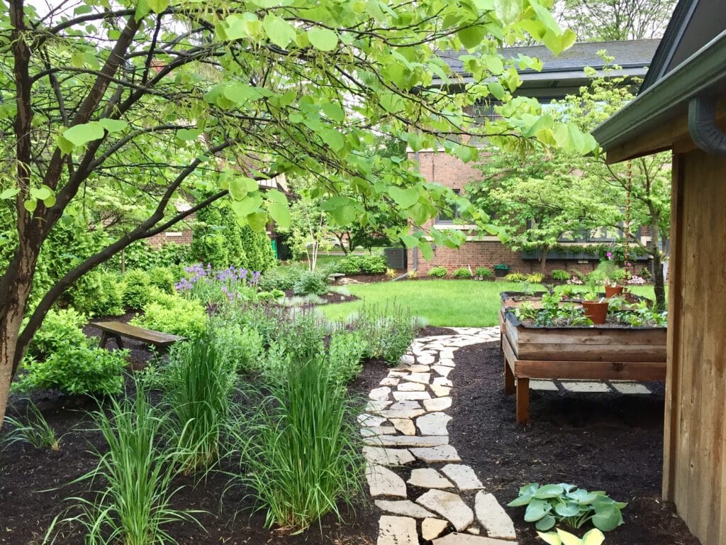Lush garden path surrounded by greenery and vibrant flowers, inviting tranquility and beauty.
