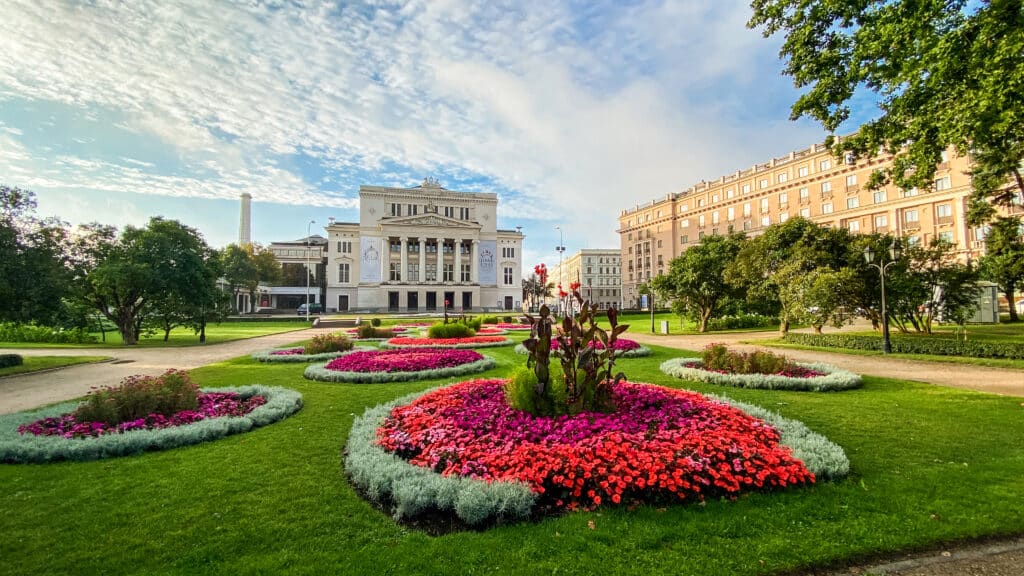 Latvian National Opera and Ballet surrounded by vibrant flower gardens in Riga, Latvia.