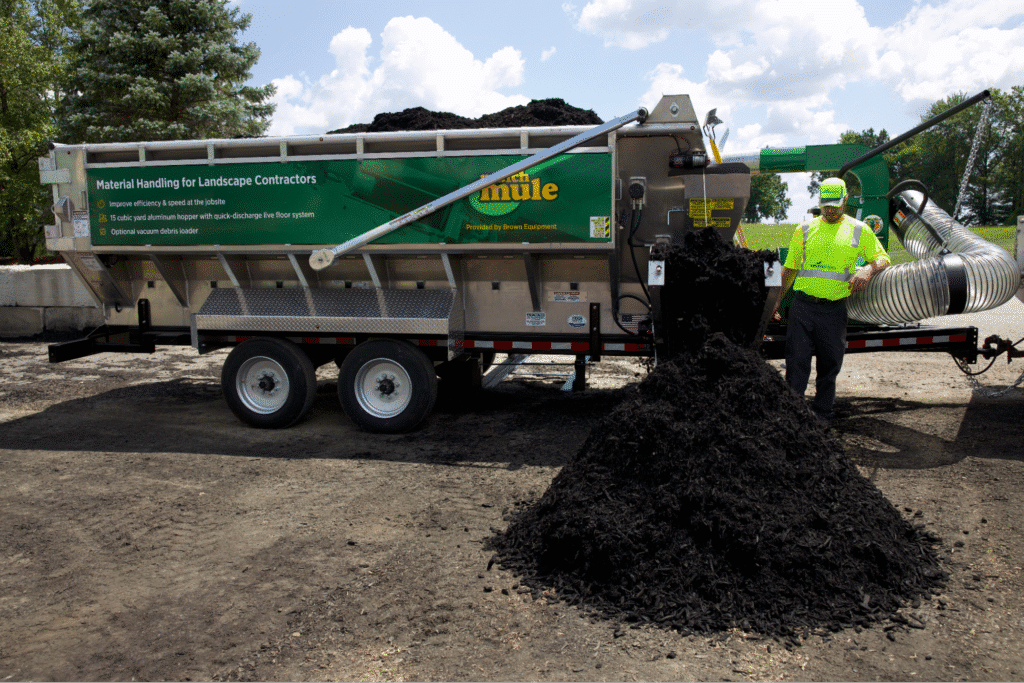 Landscape contractor using mulch hauling equipment for a landscaping project