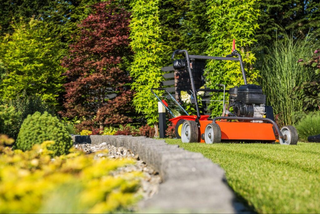 Lawn care equipment maintaining a well-manicured garden in bright sunlight.