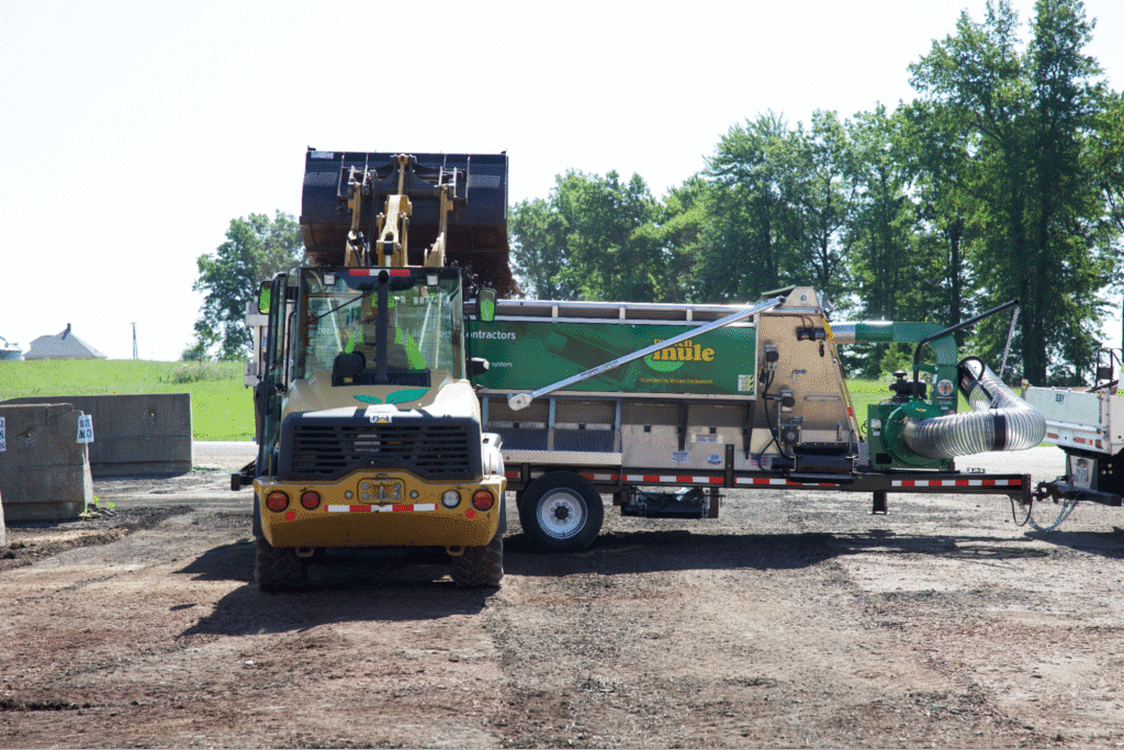 bulk mulch equipment trailer on a worksite ready for excavation and landscaping tasks.