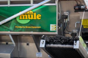 Mule machine feature from Brown Equipment, showing a conveyor mechanism for efficient material handling.