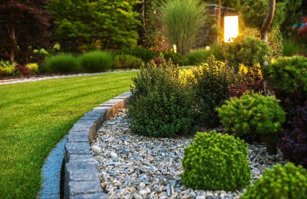 Lush garden design featuring vibrant plants and decorative stone borders for landscaping inspiration.