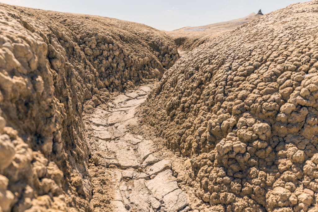 Dusty terrain shows severe soil erosion effects in drought conditions.