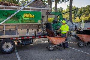 Effortlessly fill wheelbarrows with mulch using the Mulch Mule trailer.