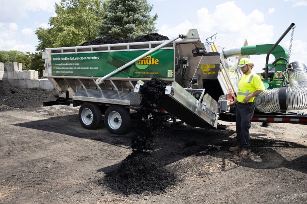 Mulch Mule landscape material dispenser in action, efficiently delivering mulch for contractors.