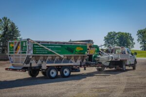 Efficient mulch delivery system with Mulch Mule equipment in sunny outdoor conditions.