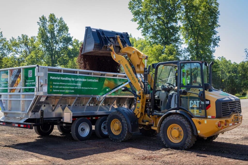 Heavy machinery unloading materials for a landscaping project efficiently and safely.
