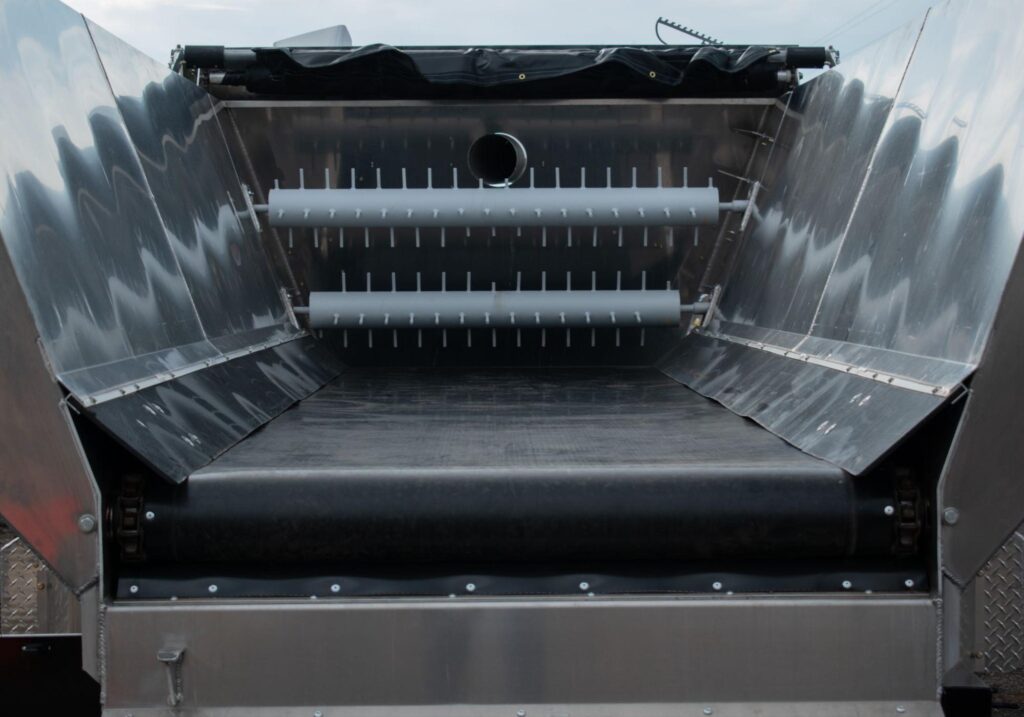 Interior view of Mulch Mule with metal frame and conveyor rollers for material handling.