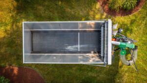 Aerial view of an Efficient Mulch Mule live floor trailer in a yard.